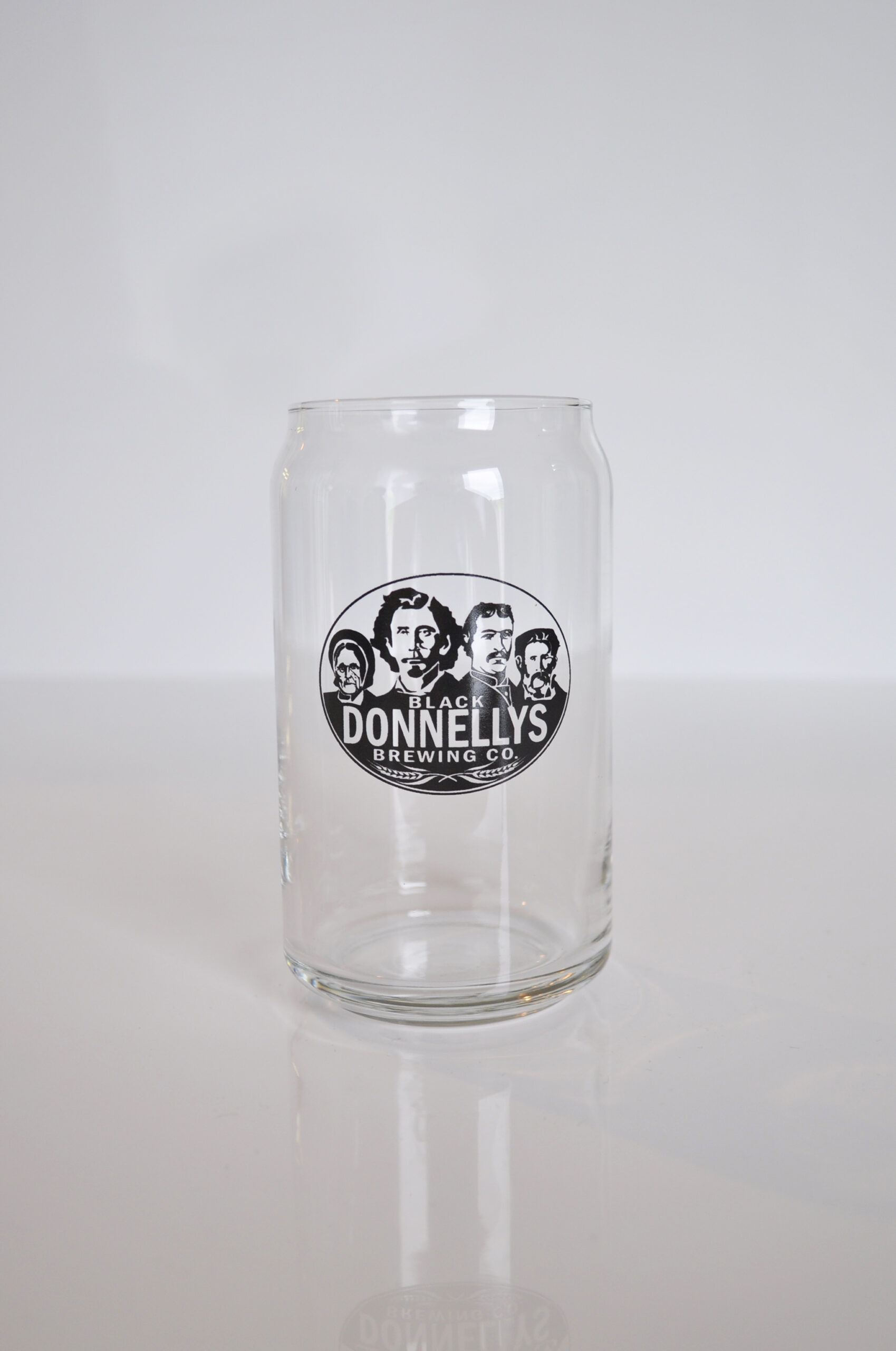 A tall Black Donnellys Brewing Company beer glass decorated with the company logo.